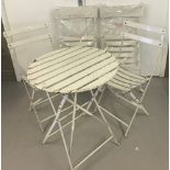 A 5 piece modern metal bistro set in white.