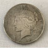 A 1925 silver Peace dollar converted to a brooch.