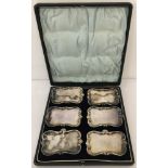 A boxed set of six silver plated, patented Walker and Hall, condiment trays to clip on side plates.