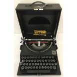 A vintage cased Imperial typewriter with original cleaning accessories.