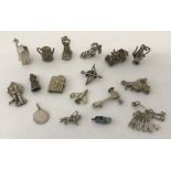 A collection of silver and white metal vintage charms.