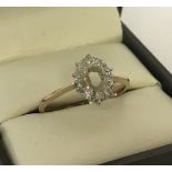 A 9ct gold dress ring with 10 small diamonds. Central stone missing.