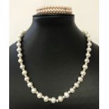 A white freshwater pearl and silver bead necklace.