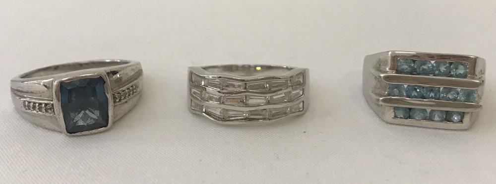 Three men's stone set silver rings.