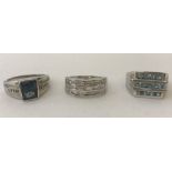 Three men's stone set silver rings.