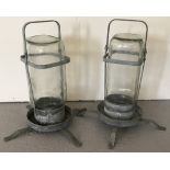A pair of vintage galvanized metal and glass bird drinkers.