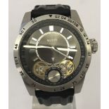 A men's chronograph skeleton watch by Guess. With black silicone strap. 30 meters water resistant.