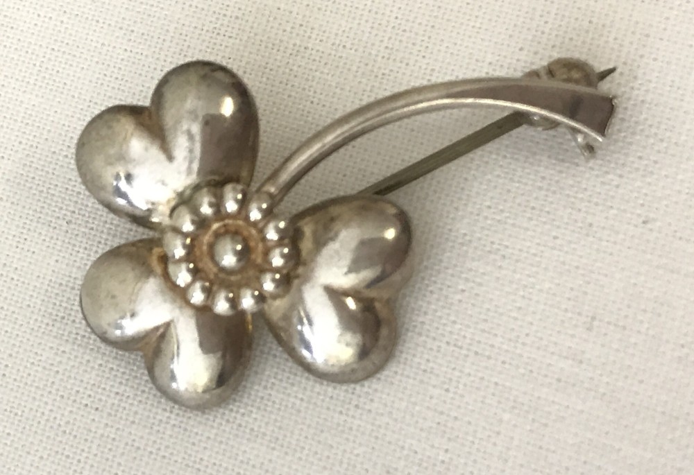 A modernist Danish silver brooch by Herman Siersbol in the shape of a clover leaf.