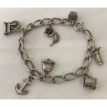 A white metal charm bracelet with 7 silver and white metal charms.