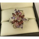 A 925 silver ladies stone set dress ring in floral design.