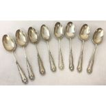 8 silver teaspoons with floral decoration to handles.