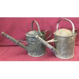 Two vintage galvanized one gallon watering cans.