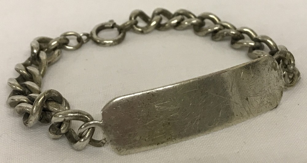 A large silver identity bracelet with empty cartouche.