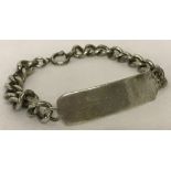 A large silver identity bracelet with empty cartouche.