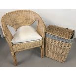 A modern light wood basket chair together with a fabric lined linen basket with lift up lid.