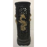 A vintage circular cast iron black and gold stick stand with oriental dragon design.