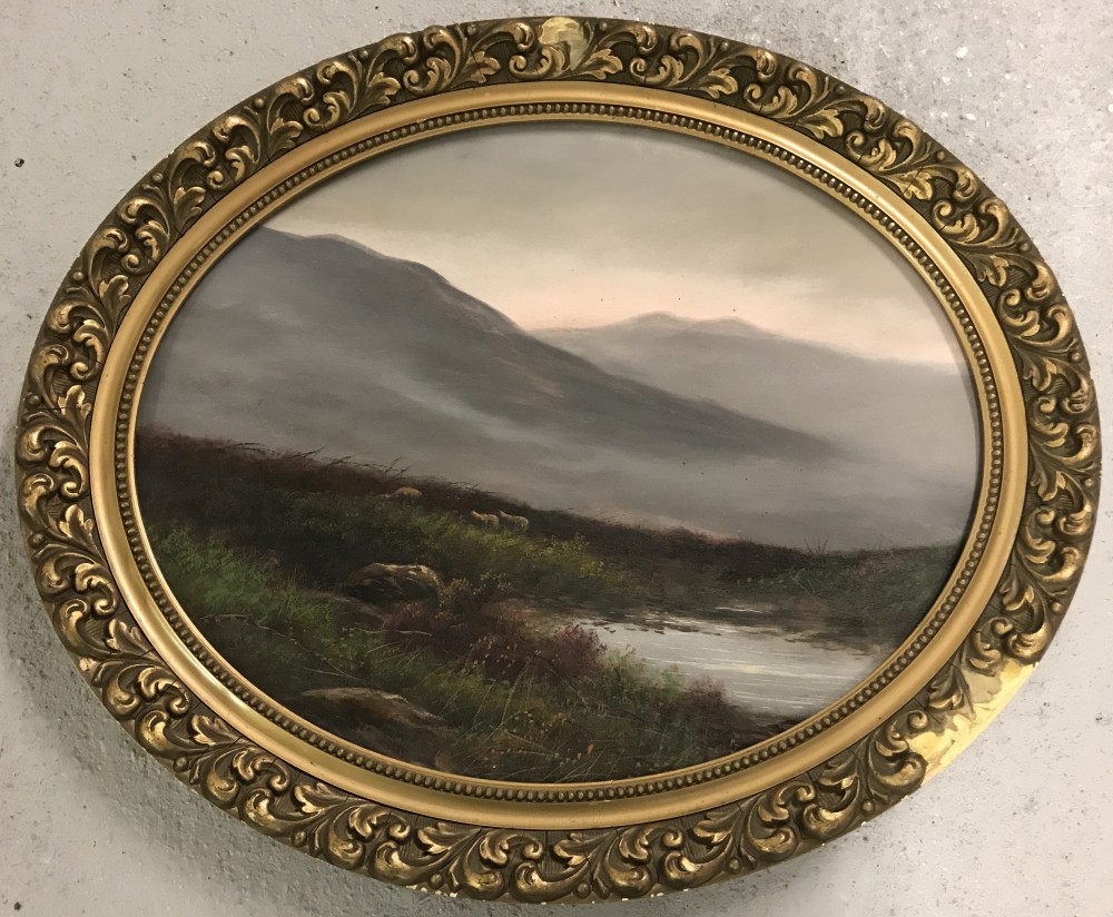 Oval shaped oil on board of a Scottish heathland scene in ornate gilt frame.