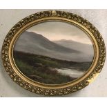 Oval shaped oil on board of a Scottish heathland scene in ornate gilt frame.