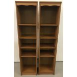 A pair of modern teak slimline bookcases each with 4 adjustable shelves.