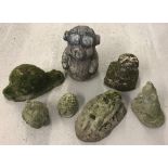 A collection of 7 assorted small concrete garden ornaments.