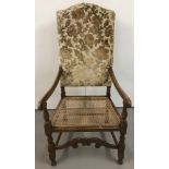 A large upright hall chair with carved front stretcher.