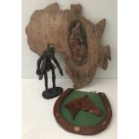 A carved wooden Africa wall plaque together with a wooden tribal figure & a horseshoe shaped plaque