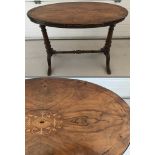 A Victorian oval topped occasional table with turned detail to base and inlaid top.