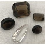4 loose smocked quartz gemstones together with a teardrop cut rock crystal stone.