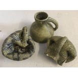 Three small concrete jug garden ornaments.