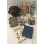 A collection of mixed items to include military badges, vintage tins and Harrods playing cards.