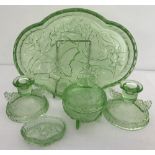 An Art Deco green glass ladies dressing table set with butterfly detail.