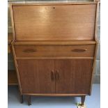 A vintage teak bureau with single drawer and double door cupboard.