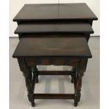 A dark wood nest of 3 tables with vintage rose carving to sides.
