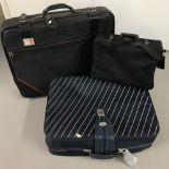 A large Constellation suitcase together with a large Revelation suitcase and a travel bag.