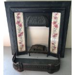A cast iron fire surround with Art Nouveau decoration and floral tiles to both sides.