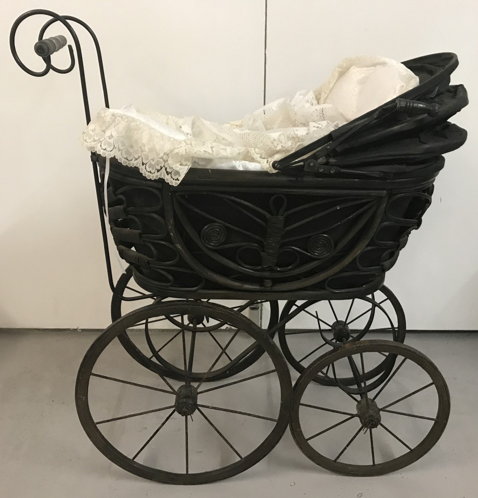 A reproduction vintage style dolls pram.