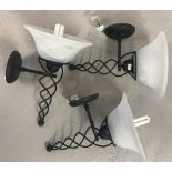 A set of 3 modern black metal wall lights with spiral detail.