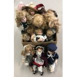 A box of 18 modern porcelain dolls in traditional dress.