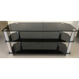 A black glass and chrome tv/entertainment unit.