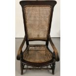 A Victorian cane back bedroom arm chair.
