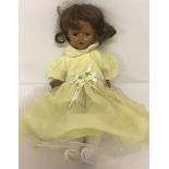 A vintage composition doll with jointed body and closing eyes.
