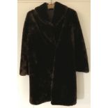 A vintage ladies fur coat with hook fastenings.