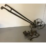A vintage wooden handled Planet Junior push cultivator complete with a selection of attachments.