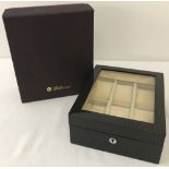 A boxed Walwood glass-topped watch box.