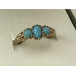 A ladies 9ct gold classic dress ring set with 3 turquoise stones.