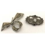 A vintage silver brooch in the shape of a decorative bow. Marked VA 925.