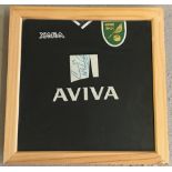 A framed and glazed Norwich City Football Club Xara away shirt 2009/10 signed by Cody McDonald.