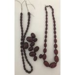 A broken string of cherry amber Bakelite beads in graduating sizes.
