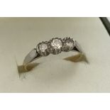 A ladies 18ct gold and palladium Past, Present and Future diamond set trilogy ring.