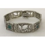 A pierced work panel silver bracelet set with Malachite.